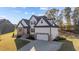 Stunning exterior view of a home showcasing beautiful landscaping, stone accents, and a two-car garage at 148 Hook Dr # 7, Fuquay Varina, NC 27526