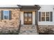 Elegant front entrance with stone steps, a double-door entry, and decorative shutters at 148 Hook Dr # 7, Fuquay Varina, NC 27526