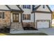 Inviting front of home showcasing stone accents, a double-door entry, and lush landscaping at 148 Hook Dr # 7, Fuquay Varina, NC 27526