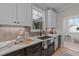 Kitchen features a farmhouse sink, stainless steel appliances, and white cabinets at 148 Hook Dr # 7, Fuquay Varina, NC 27526