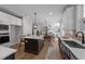Open kitchen with a large island and a view of the dining area and living room at 148 Hook Dr # 7, Fuquay Varina, NC 27526