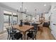 Well-lit kitchen with center island and a view to the screened porch with outdoor seating area at 148 Hook Dr # 7, Fuquay Varina, NC 27526