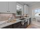 Updated kitchen featuring white cabinets, a stainless steel sink, and dark-stained lower cabinets at 148 Hook Dr # 7, Fuquay Varina, NC 27526