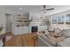 Cozy living room features a fireplace with built-ins, hardwood floors, and a modern ceiling fan at 148 Hook Dr # 7, Fuquay Varina, NC 27526