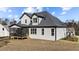 Stunning new build with white siding, dark roof, and screened-in back porch at 148 Hook Dr # 7, Fuquay Varina, NC 27526