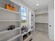 Spacious walk-in closet with custom shelving, storage baskets, and a window at 148 Hook Dr # 7, Fuquay Varina, NC 27526
