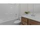 Bathroom showcases a combination tub and shower, and wooden cabinets at 65 Diamond Creek Dr, Zebulon, NC 27597