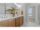 Bathroom boasts dual sinks, wood cabinets, and marble flooring at 65 Diamond Creek Dr, Zebulon, NC 27597