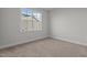 Bright bedroom features neutral walls, carpet flooring, and a large window at 65 Diamond Creek Dr, Zebulon, NC 27597