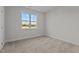 Bedroom features neutral walls, carpet flooring, and a window at 65 Diamond Creek Dr, Zebulon, NC 27597
