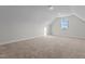 An open bonus room with carpet and a single window for natural light at 65 Diamond Creek Dr, Zebulon, NC 27597