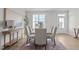 Bright dining room with natural light, featuring a modern table, seating for six, and elegant decor at 65 Diamond Creek Dr, Zebulon, NC 27597