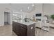 Open-concept home featuring a kitchen island with seating overlooking the living area and fireplace at 65 Diamond Creek Dr, Zebulon, NC 27597