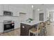 Modern kitchen featuring stainless steel appliances, a kitchen island with barstools, and white subway tile backsplash at 65 Diamond Creek Dr, Zebulon, NC 27597