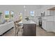 Stylish kitchen with stainless steel appliances, a large island with seating, and white cabinetry at 65 Diamond Creek Dr, Zebulon, NC 27597