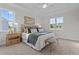 Bright main bedroom features a tufted headboard, stylish decor, and two windows at 65 Diamond Creek Dr, Zebulon, NC 27597
