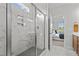 Elegant walk-in shower with marble tiling, dual shower heads, and built-in shelves at 65 Diamond Creek Dr, Zebulon, NC 27597