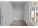 Walk-in closet features carpet flooring, built-in shelving, and a window at 65 Diamond Creek Dr, Zebulon, NC 27597