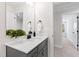 Neutral bathroom vanity with white countertops, black hardware, and a decorative plant at 108 Nakoma Dr, Louisburg, NC 27549