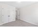 Empty bedroom with double closet door and neutral carpet at 108 Nakoma Dr, Louisburg, NC 27549