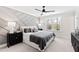 Cozy bedroom with decorative accent wall, ceiling fan, and bright windows offering a view of nature at 108 Nakoma Dr, Louisburg, NC 27549
