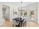 Stylish dining room featuring a modern chandelier, hardwood floors, and a door to the backyard at 108 Nakoma Dr, Louisburg, NC 27549