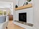 Close-up on the living room fireplace with white mantle and plank wall accent at 108 Nakoma Dr, Louisburg, NC 27549