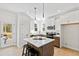 Modern kitchen with white cabinets, stainless steel appliances, a large center island, and pendant lights at 108 Nakoma Dr, Louisburg, NC 27549
