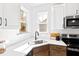 Modern kitchen with white cabinets, stainless steel appliances, and a large window above the sink at 108 Nakoma Dr, Louisburg, NC 27549