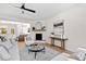 Bright living room featuring a fireplace with modern decor, plush seating, and hardwood floors at 108 Nakoma Dr, Louisburg, NC 27549