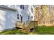 A view of the house shows the back deck with stairs leading to the yard at 158 Nakoma Dr, Louisburg, NC 27549