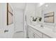 Bathroom showcasing white cabinets, countertops, and a large mirror with modern fixtures at 158 Nakoma Dr, Louisburg, NC 27549