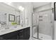 Modern bathroom with double vanity sinks, a glass-enclosed shower, and elegant fixtures at 158 Nakoma Dr, Louisburg, NC 27549