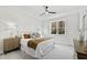 Spacious bedroom with a ceiling fan, plush carpet, and a window overlooking the backyard at 158 Nakoma Dr, Louisburg, NC 27549