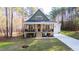 Beautiful two-story home boasts a cozy front porch and lush green lawn at 158 Nakoma Dr, Louisburg, NC 27549