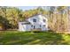 A view of the house exterior shows a back deck and a large, well-manicured lawn with a wooded backdrop at 158 Nakoma Dr, Louisburg, NC 27549