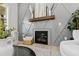 Modern fireplace with stylish gray accent wall and elegant decorative elements at 158 Nakoma Dr, Louisburg, NC 27549