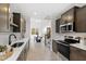 Well-lit kitchen with stainless steel appliances, modern countertops, and hardwood floors throughout at 158 Nakoma Dr, Louisburg, NC 27549