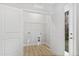 Spacious laundry room featuring wood floor and closet with shelving at 158 Nakoma Dr, Louisburg, NC 27549