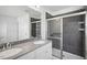 Modern bathroom with double sink vanity and tile shower with glass door at 305 Chestnut Oak Ln, Lillington, NC 27546