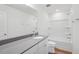 A bright bathroom with a large mirror, vanity, and tub shower at 305 Chestnut Oak Ln, Lillington, NC 27546