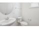 Modern half bath with a white sink, toilet, and fixtures at 305 Chestnut Oak Ln, Lillington, NC 27546