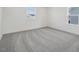 A spacious bedroom with neutral carpet and lots of natural light at 305 Chestnut Oak Ln, Lillington, NC 27546