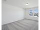A bright bedroom with large windows and neutral carpet at 305 Chestnut Oak Ln, Lillington, NC 27546