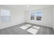 Bright bedroom with plush carpet and large windows at 305 Chestnut Oak Ln, Lillington, NC 27546