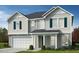 Charming two-story home with a two-car garage and well-maintained lawn at 305 Chestnut Oak Ln, Lillington, NC 27546