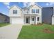 Charming two-story home with a well-manicured lawn and a classic architectural design at 305 Chestnut Oak Ln, Lillington, NC 27546