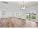 Spacious living room with natural light, wood floors, and sliding glass doors to backyard at 305 Chestnut Oak Ln, Lillington, NC 27546