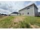View of the backyard and rear exterior of the home, showing ample space and natural surroundings at 114 Southern Estates Dr, Sanford, NC 27330