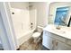 Bathroom showcasing a shower-tub combination, toilet, vanity, and tile flooring at 114 Southern Estates Dr, Sanford, NC 27330